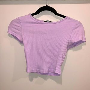 A ribbed lilac t shirt that stood just after the belly button.